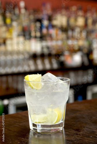 Ti punch with ice cubes and quaters of lemon. photo