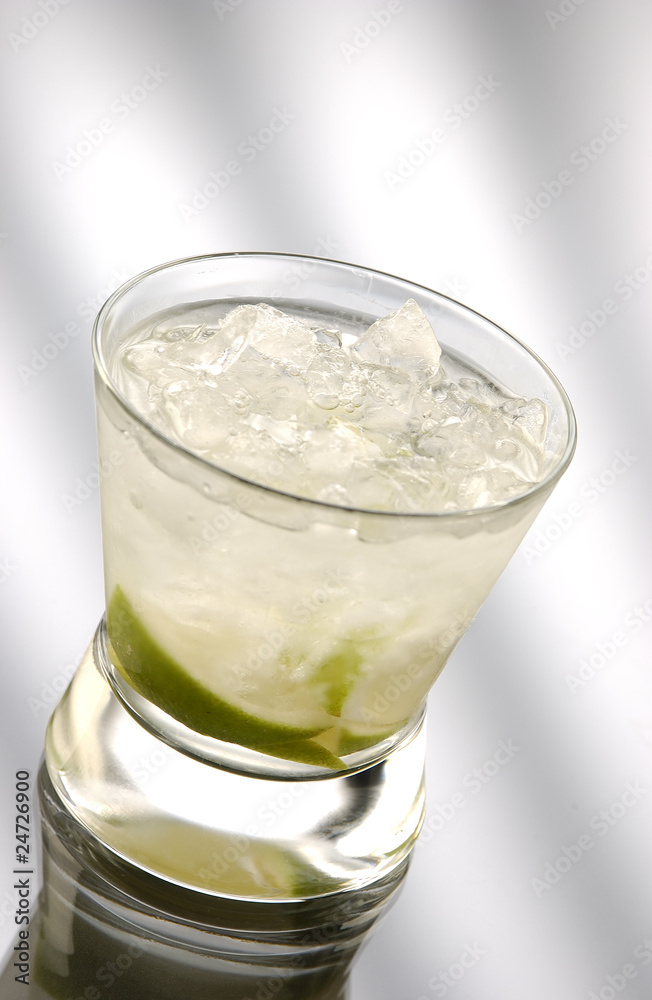 Glass of caipiriniha in front of light background Glass of caipiriniha in front of light background