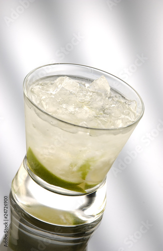 Glass of caipiriniha in front of light background photo