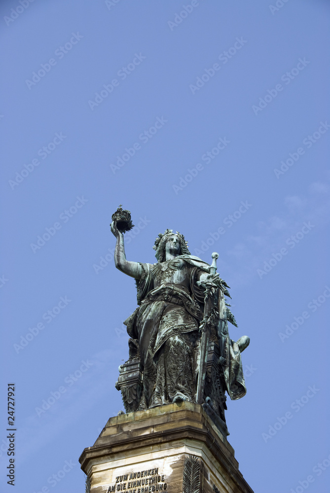 Old Angel Monument in front of clear sky.