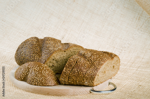 Cutted whole grain dark bread food on a texture background photo