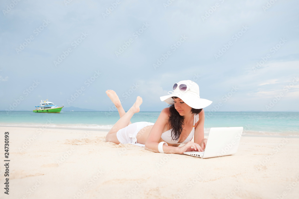 Cute woman with white laptop on the summer beach Cute woman with white laptop on the summer beach