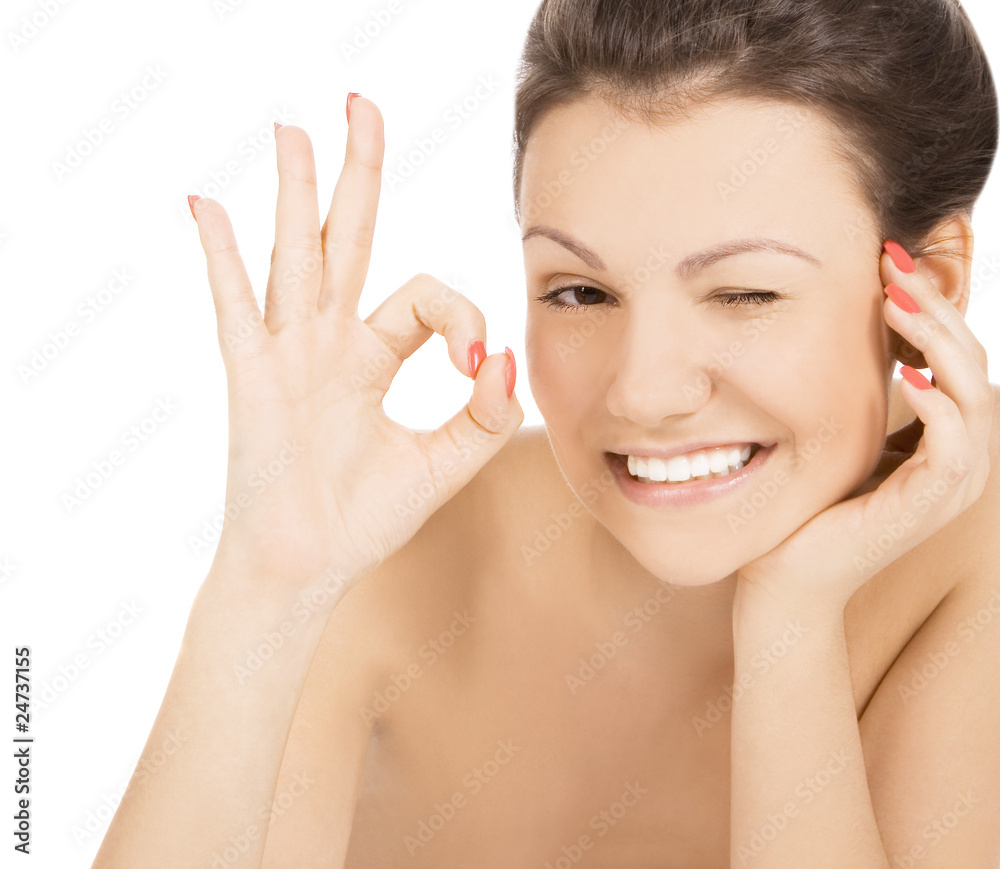 Sexy smiling woman showing OK and provocative winking Sexy smiling woman showing OK and provocative winking
