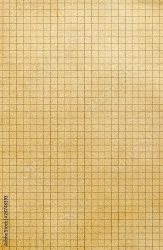 Old yellowing square paper grid close up.