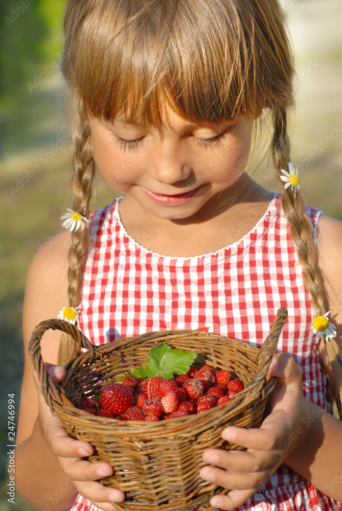 little girl and the basket of wild strawberries