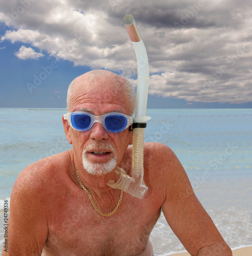 Senior man in snorkel and blue goggles