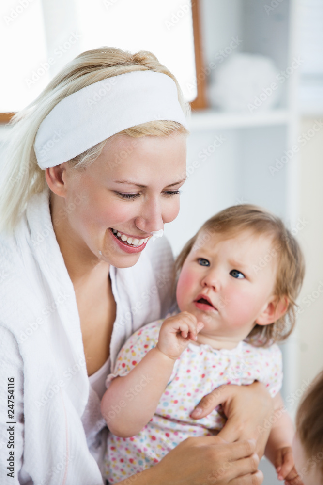 Laughing mother taking care of her children