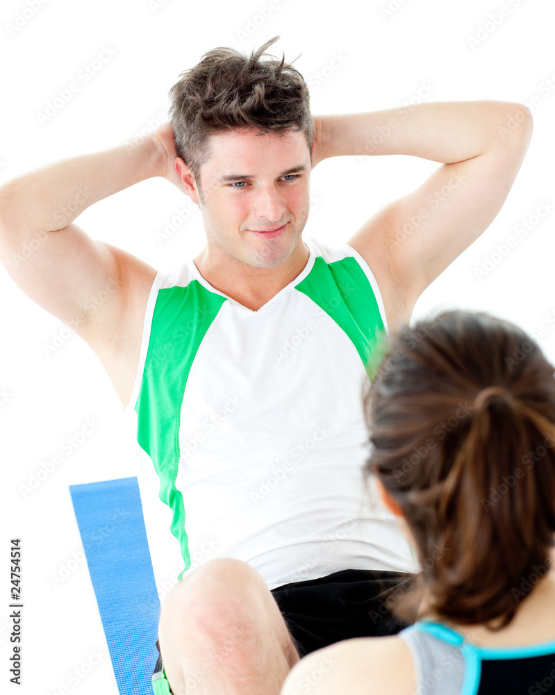 Obraz premium Handsome man doing fitness exercises with a woman