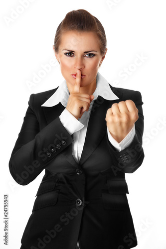 Fényképezés business woman with finger at mouth and threaten with fist