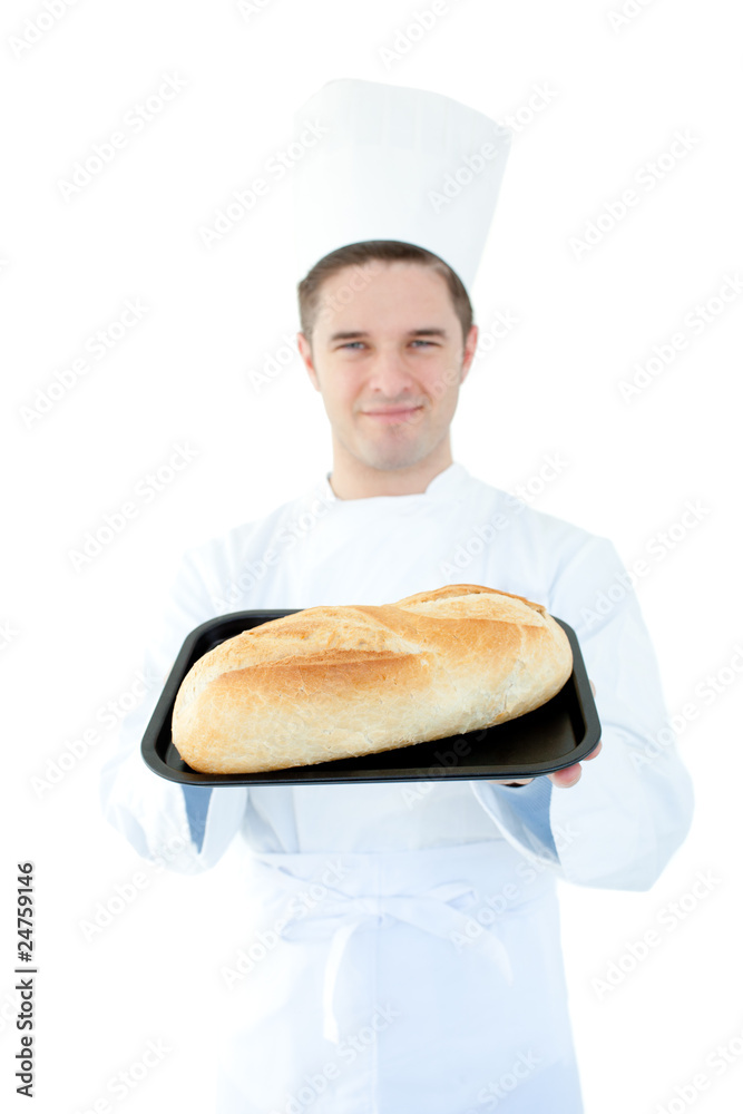 Smiling male cook holding a bread into the camera Smiling male cook holding a bread into the camera