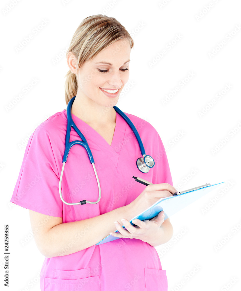 Ambitious female surgeon writing on a clipboard Ambitious female surgeon writing on a clipboard