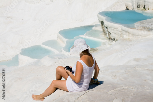 Woman sitting on white stones