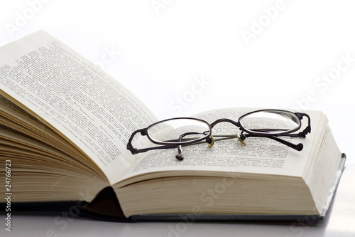 Open book with reading glasses