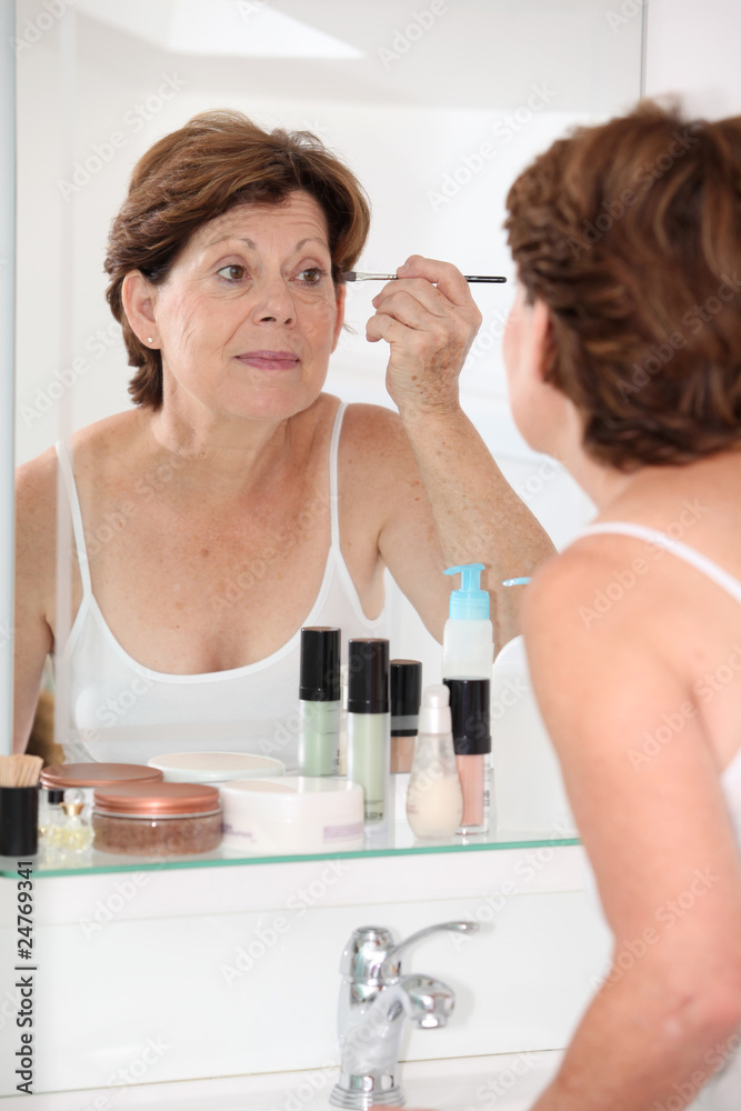 Closeup of senior woman putting makeup on Closeup of senior woman putting makeup on