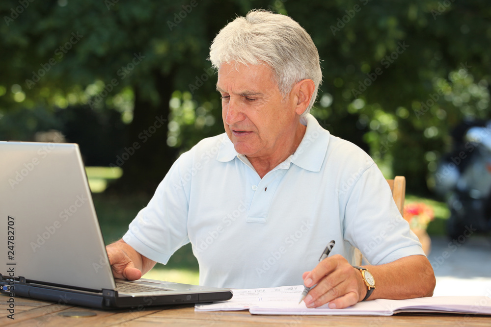 Closeup of senior man with laptop computer at home Closeup of senior man with laptop computer at home