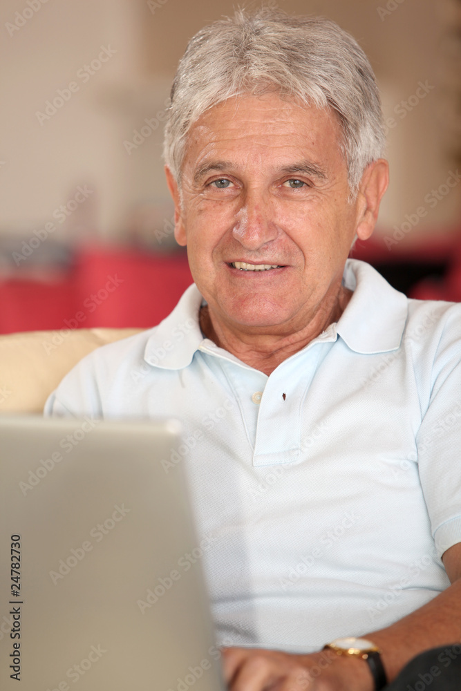 Closeup of senior man with laptop computer at home Closeup of senior man with laptop computer at home