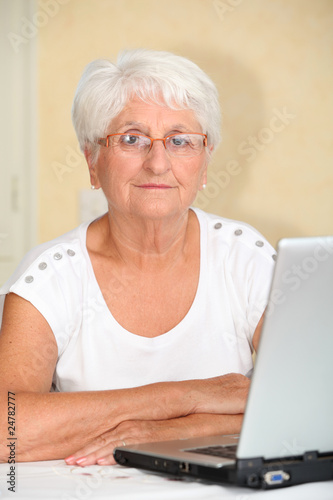 Closeup of elderly woman with laptop computer