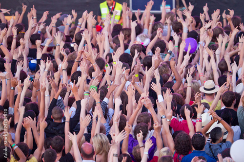crowd holding up hands photo