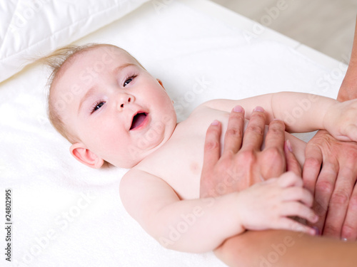 Mother massaging of newborn baby