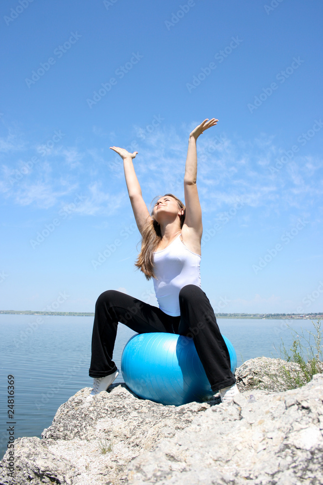 Young woman stretching to the sun Young woman stretching to the sun