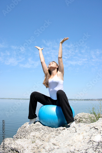 Young woman stretching to the sun