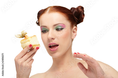 The beautiful young woman eat tasty cake