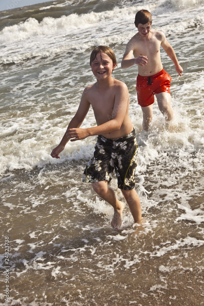 boys enjoying the beautiful ocean and beach boys enjoying the beautiful ocean and beach