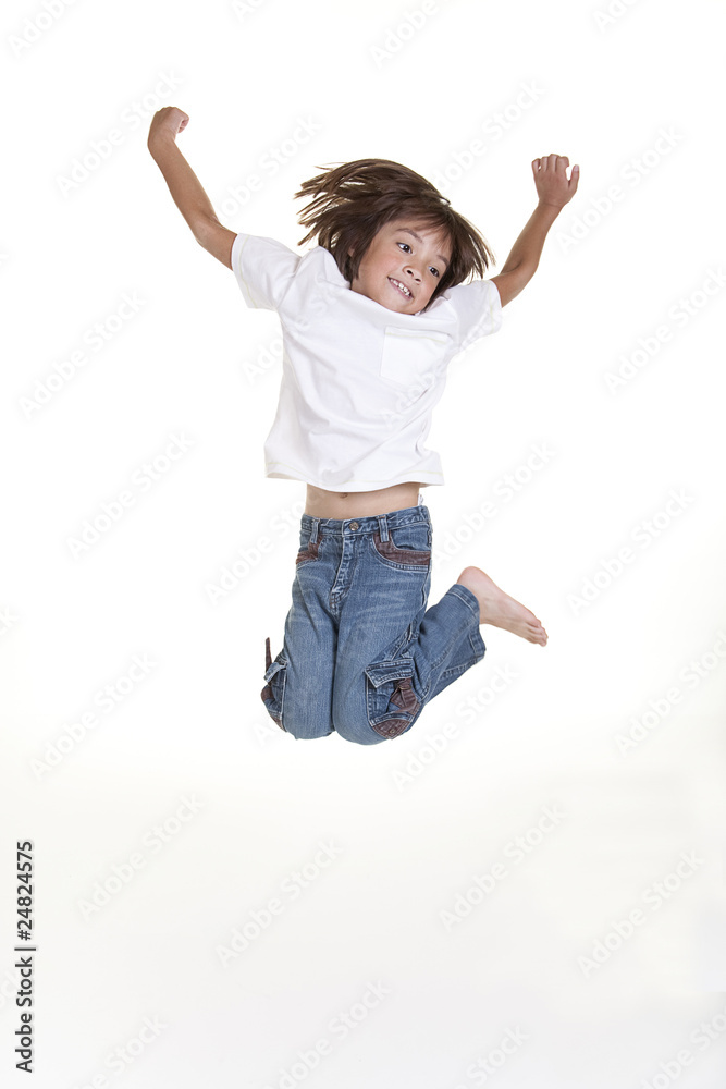A young girl jumps up in the air in this studio image.