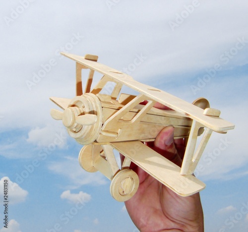 hand holds the toy plane