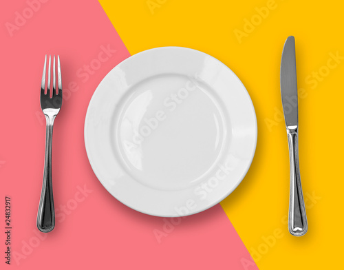 Knife  plate and fork on colorful background