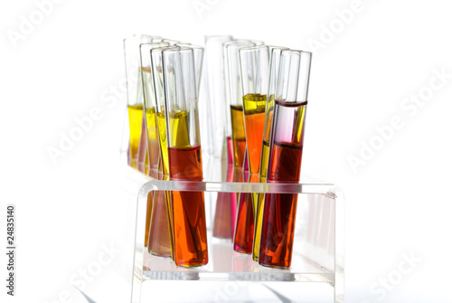 Rack with test tubes of colored liquid isolated on white