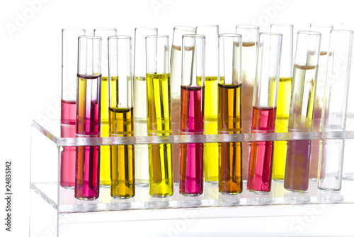 Rack with tubes of colored liquid isolated on white