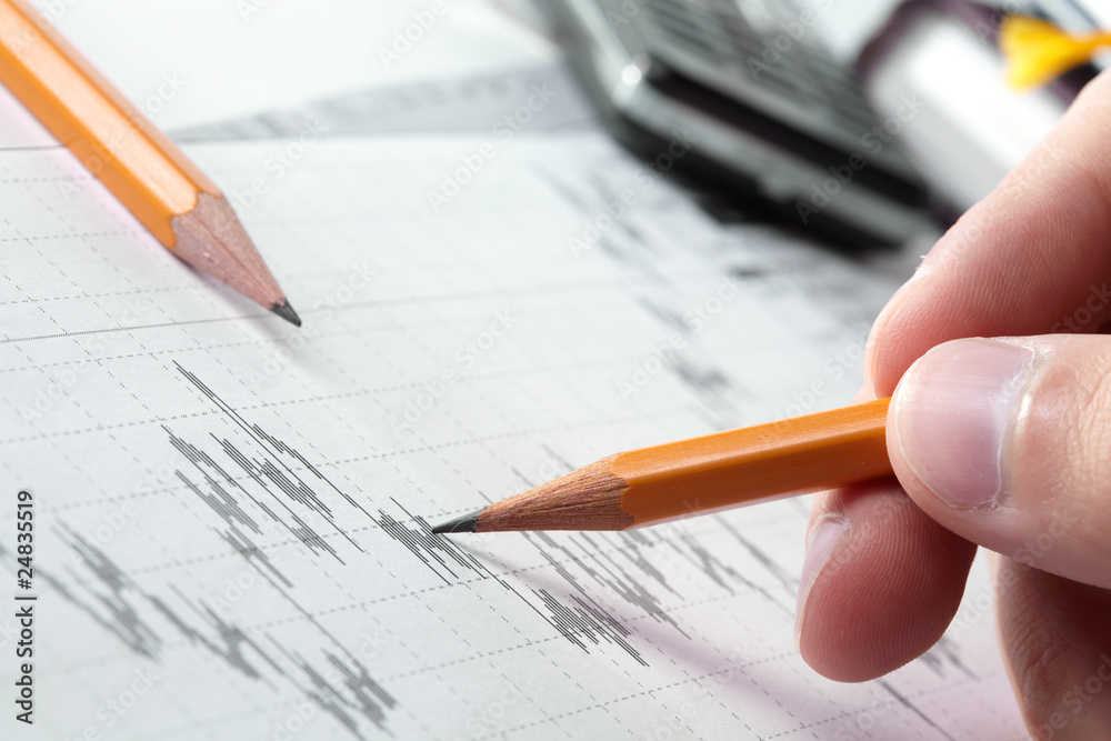 Business accessories on a background of diagrams Business accessories on a background of diagrams