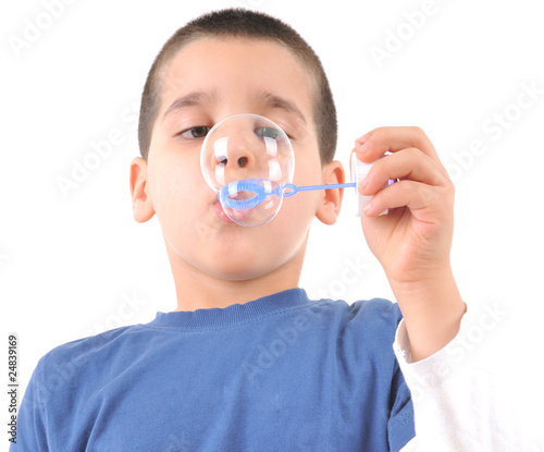 Little boy blowing soap bubbles.