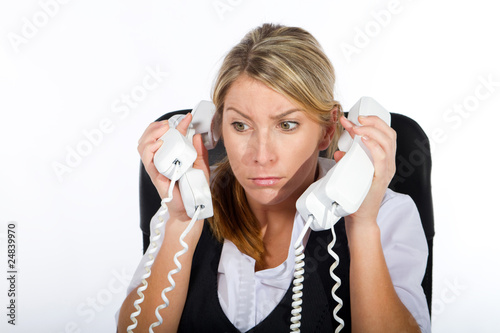 cheerful businesswoman answering alot of phones photo