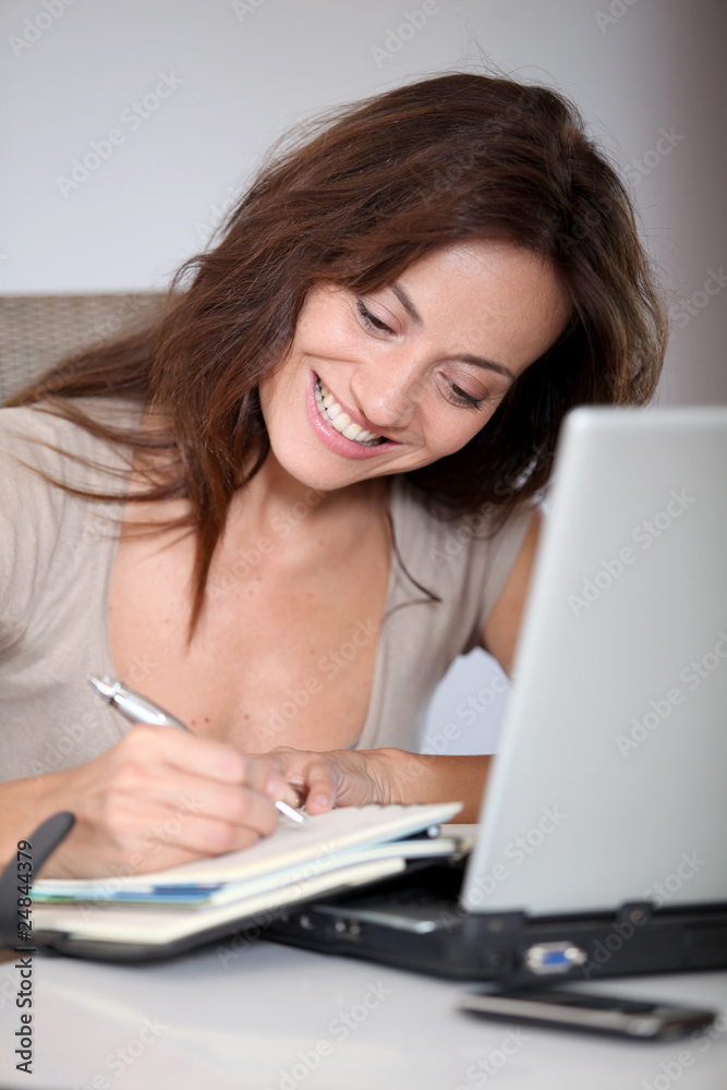 Woman working at home on laptop computer Woman working at home on laptop computer