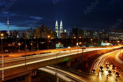 Kuala Lumpur cityscape, with light trails at night.