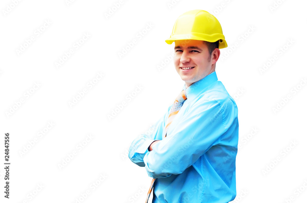 Young architect wearing a protective helmet standing on the buil Young architect wearing a protective helmet standing on the buil