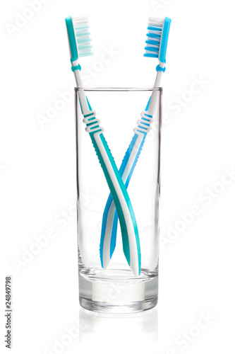 Two tooth brushes in glass