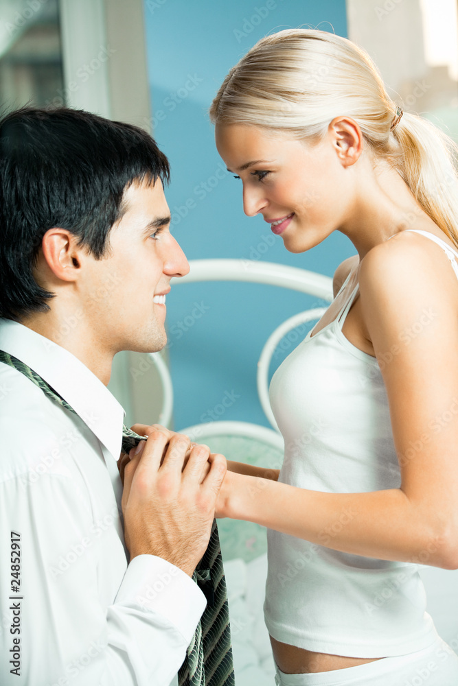 Naklejka premium Young attractive happy amorous couple at bedroom