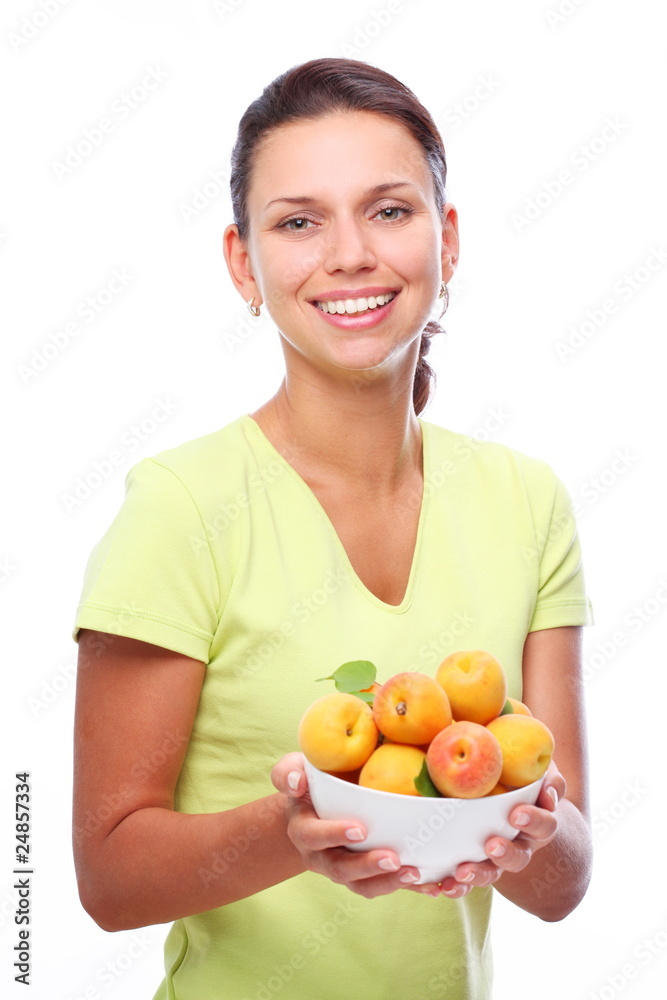 Smiling young woman keeping full bowl with apricots in her hands Smiling young woman keeping full bowl with apricots in her hands