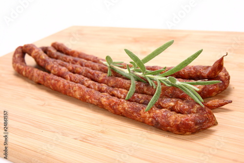 Smoked sausages on a wooden background