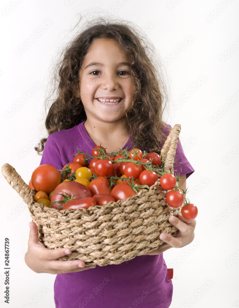 girl holdin a basket of tomatoes girl holdin a basket of tomatoes