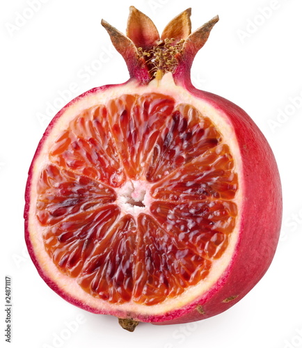 Red orange cut ripe pomegranate. Product of genetic engineering.
