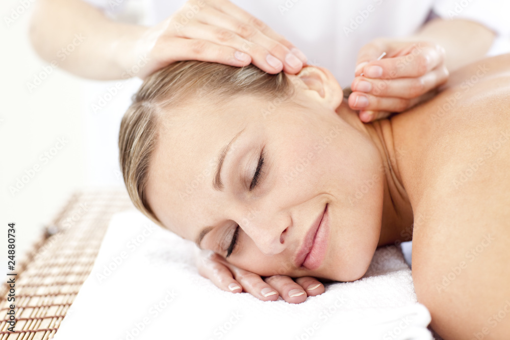 Relaxed woman receiving an acupuncture treatment Relaxed woman receiving an acupuncture treatment