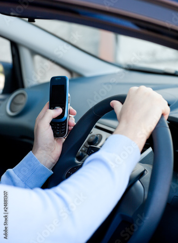 Close-up of a caucasian man sending a message while driving