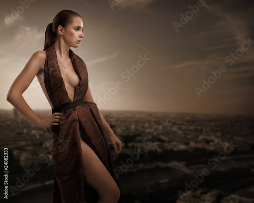 Sexy young beauty posing over urban background