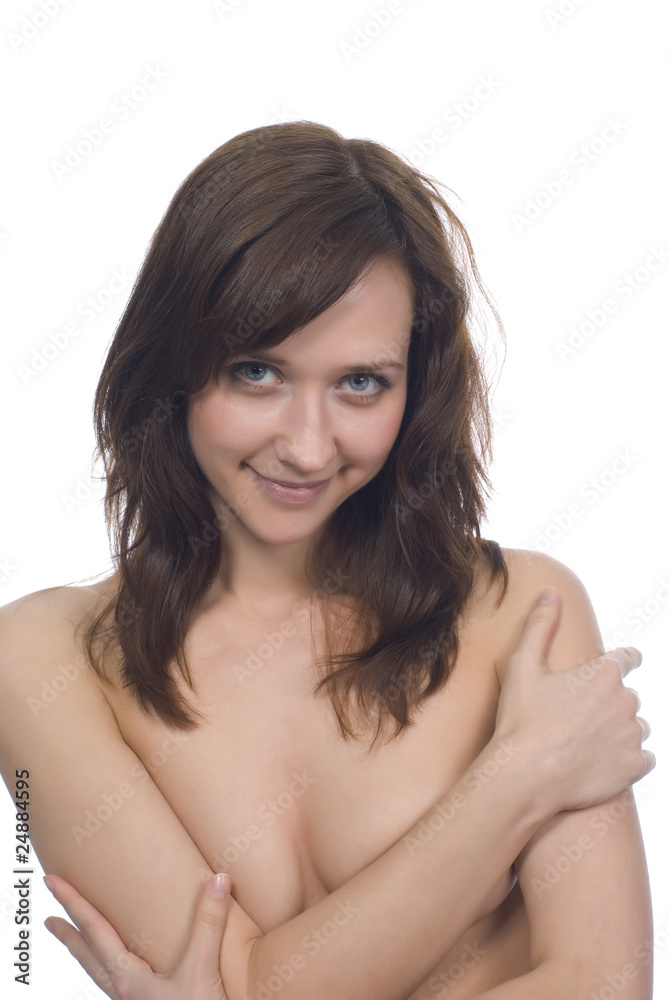 Young brunette covering her breasts isolated over white Young brunette covering her breasts isolated over white