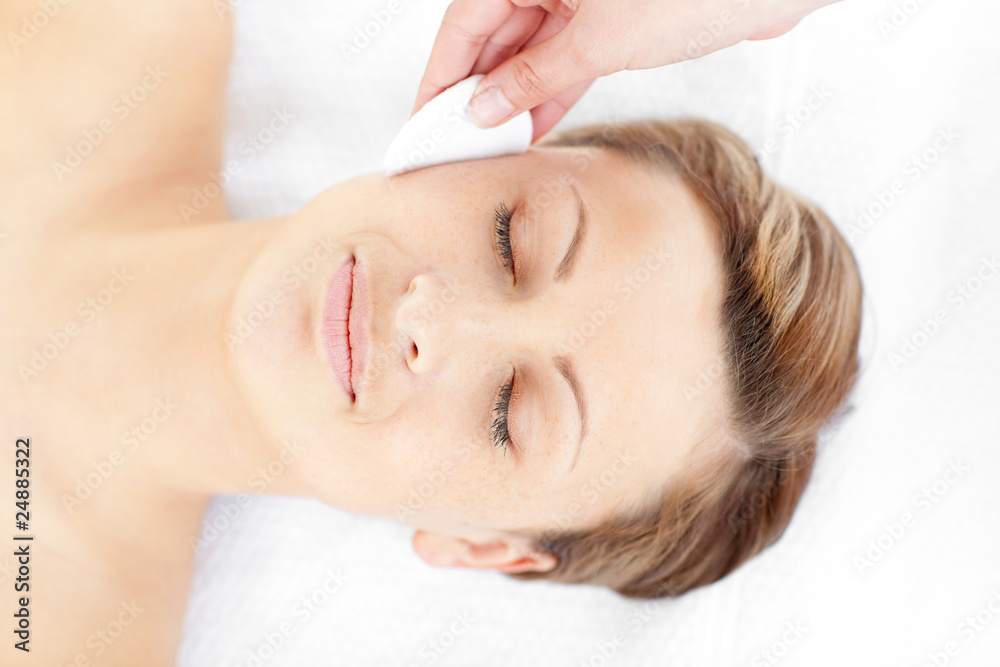 Positive young woman receiving a beauty treatment Positive young woman receiving a beauty treatment