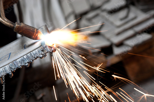 blowtorch cutting metal in factory and sparks